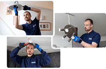 Electrician changing light fixture in a London property