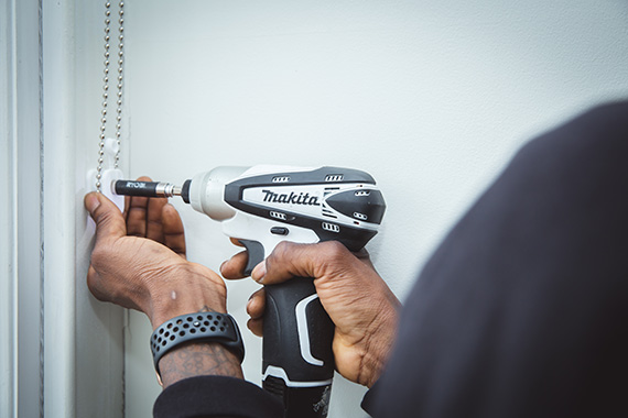 Handyman installing blinds in a London property