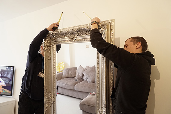 Experts fitting a mirror in a London property